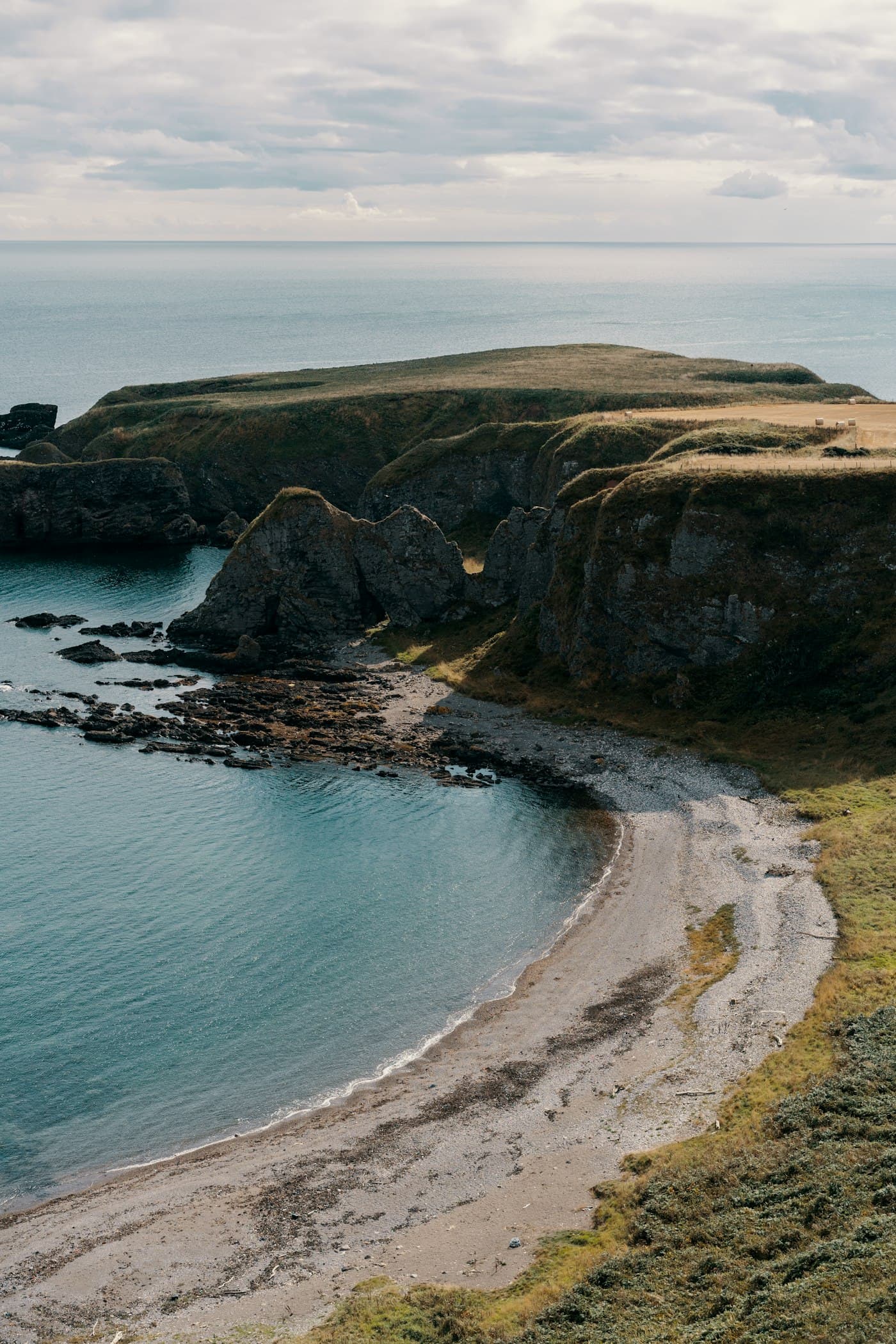 Cliffs and a shingle cove on the coast at Stonehaven, Scotland